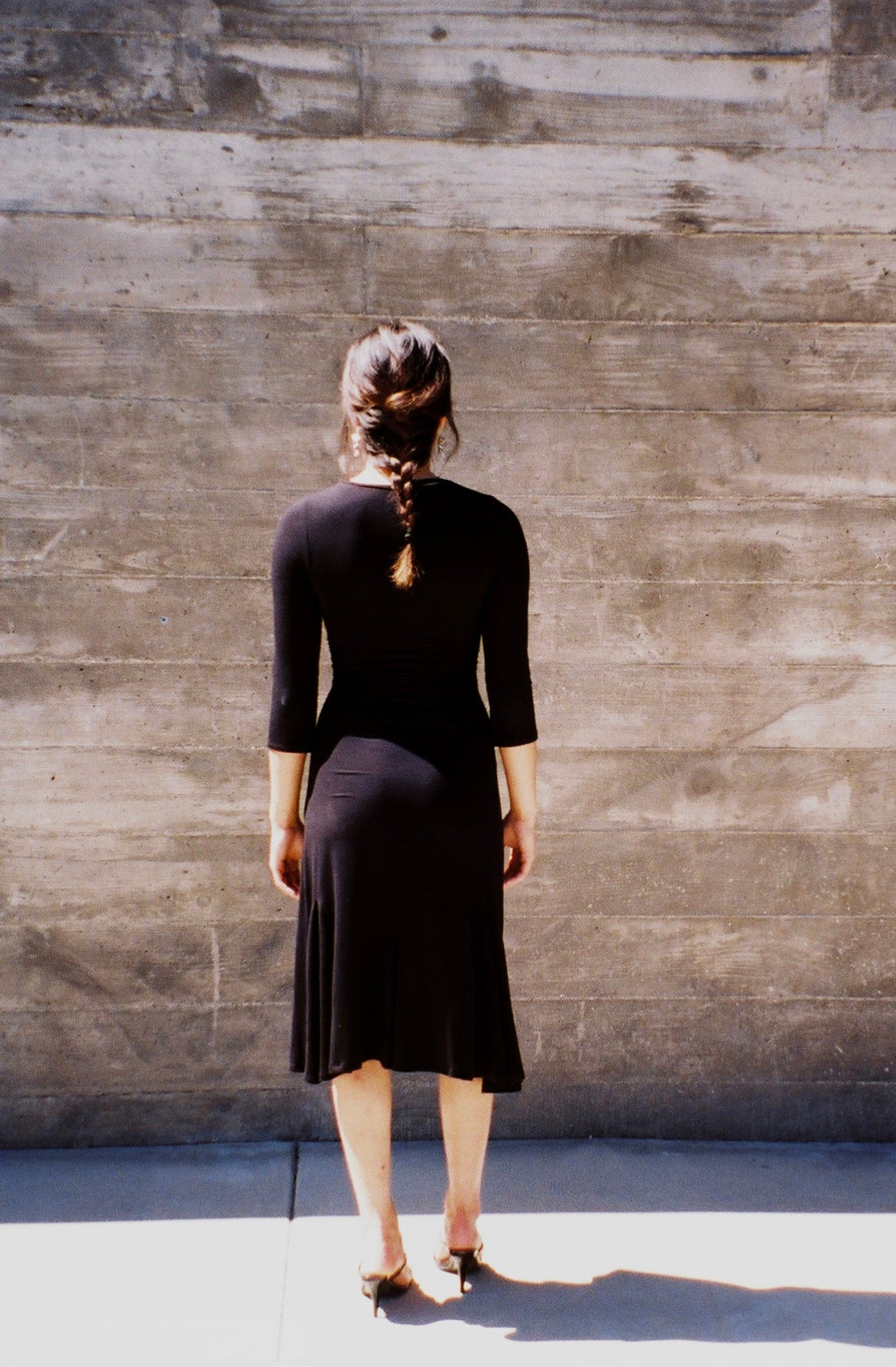 Elegant women's flowy maxi gown, Luna Dress, side view, natural light, model walking.