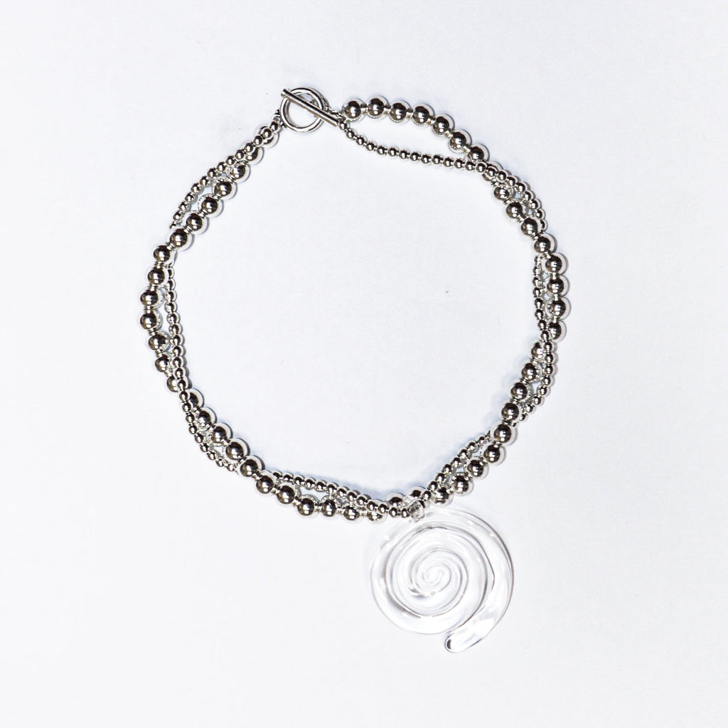 Pair of spiral hoop earrings, chic and modern jewelry, on white background.
