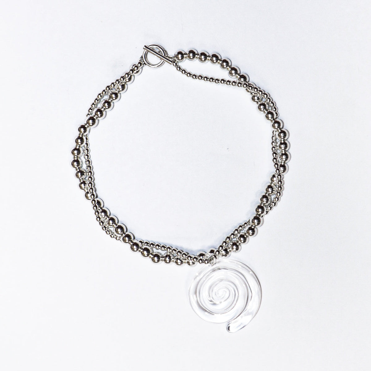 Pair of spiral hoop earrings, chic and modern jewelry, on white background.